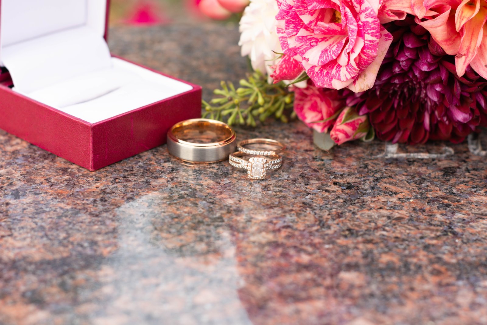 Wedding rings and engagement ring beside a bridal bouquet - Minneapolis wedding photographer