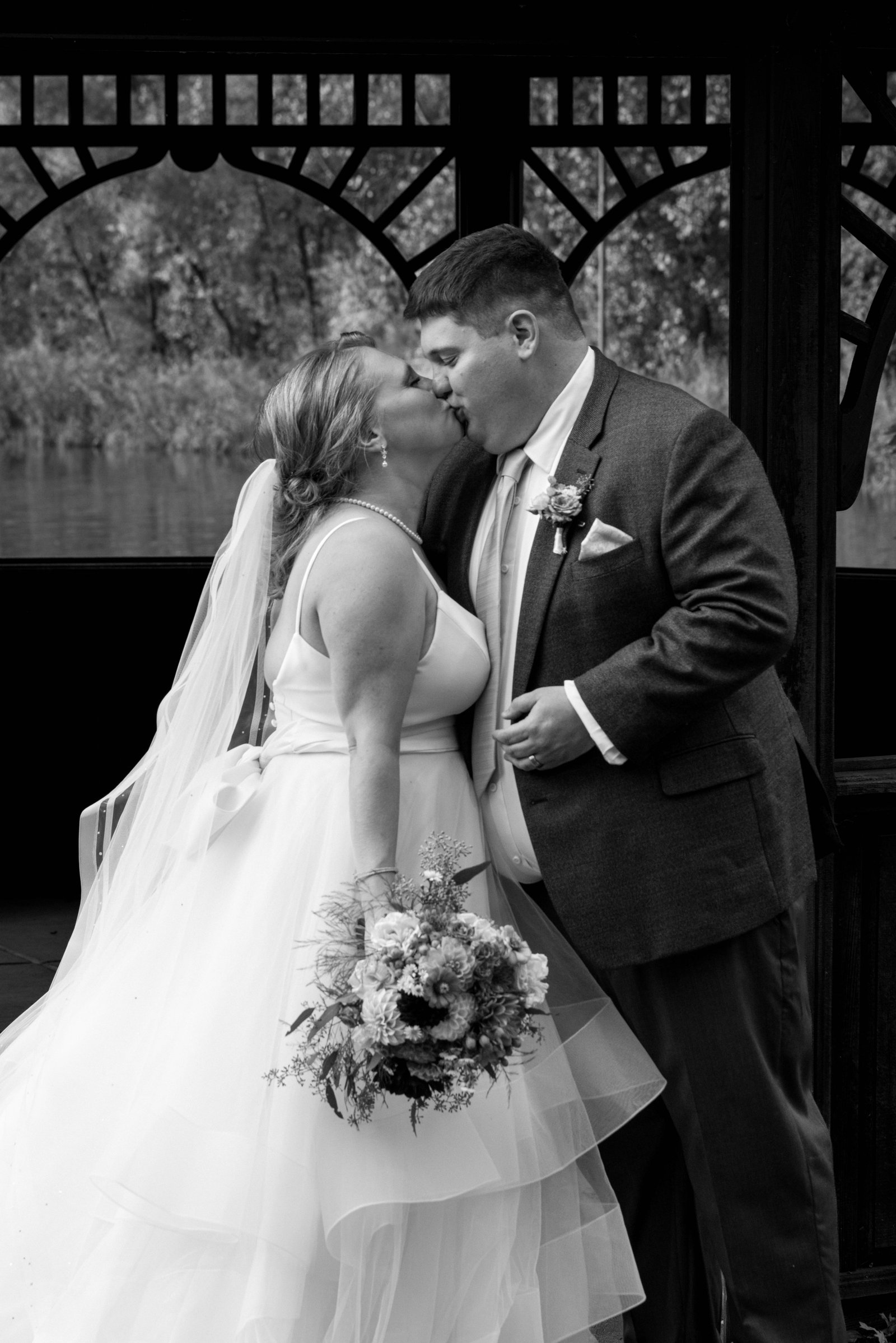 Newlyweds sharing their first kiss - Twin Cities wedding photographer Steve Lunden