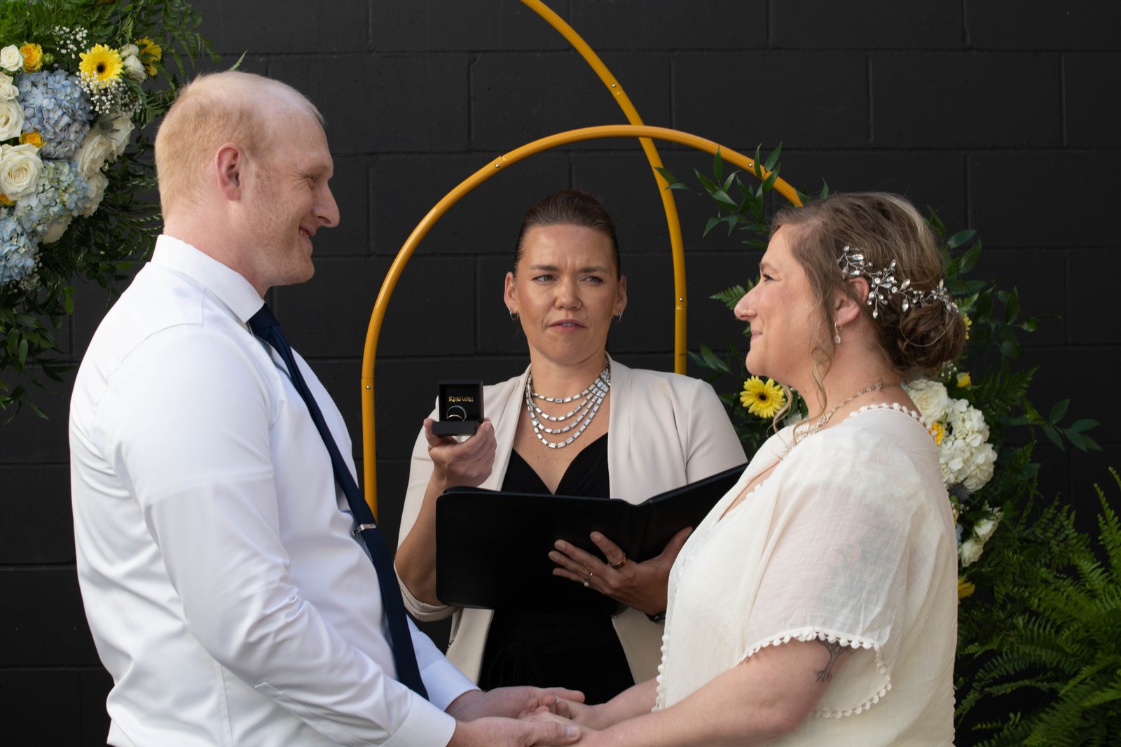 Officiant presenting the rings during the ceremony - Steve Lunden Photography